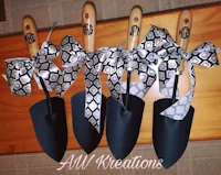 four black and white shovels with bows on them
