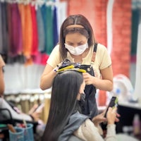 a woman is getting her hair done in a salon