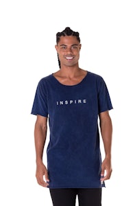 a man wearing a blue t - shirt with the word inspire on it