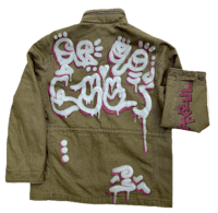 a green jacket with graffiti on it