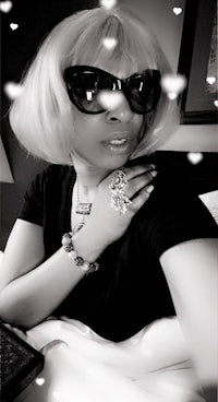 a black and white photo of a woman in sunglasses