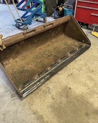 a rusted bucket sitting in a garage