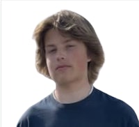 a boy in a blue t - shirt with his eyes closed