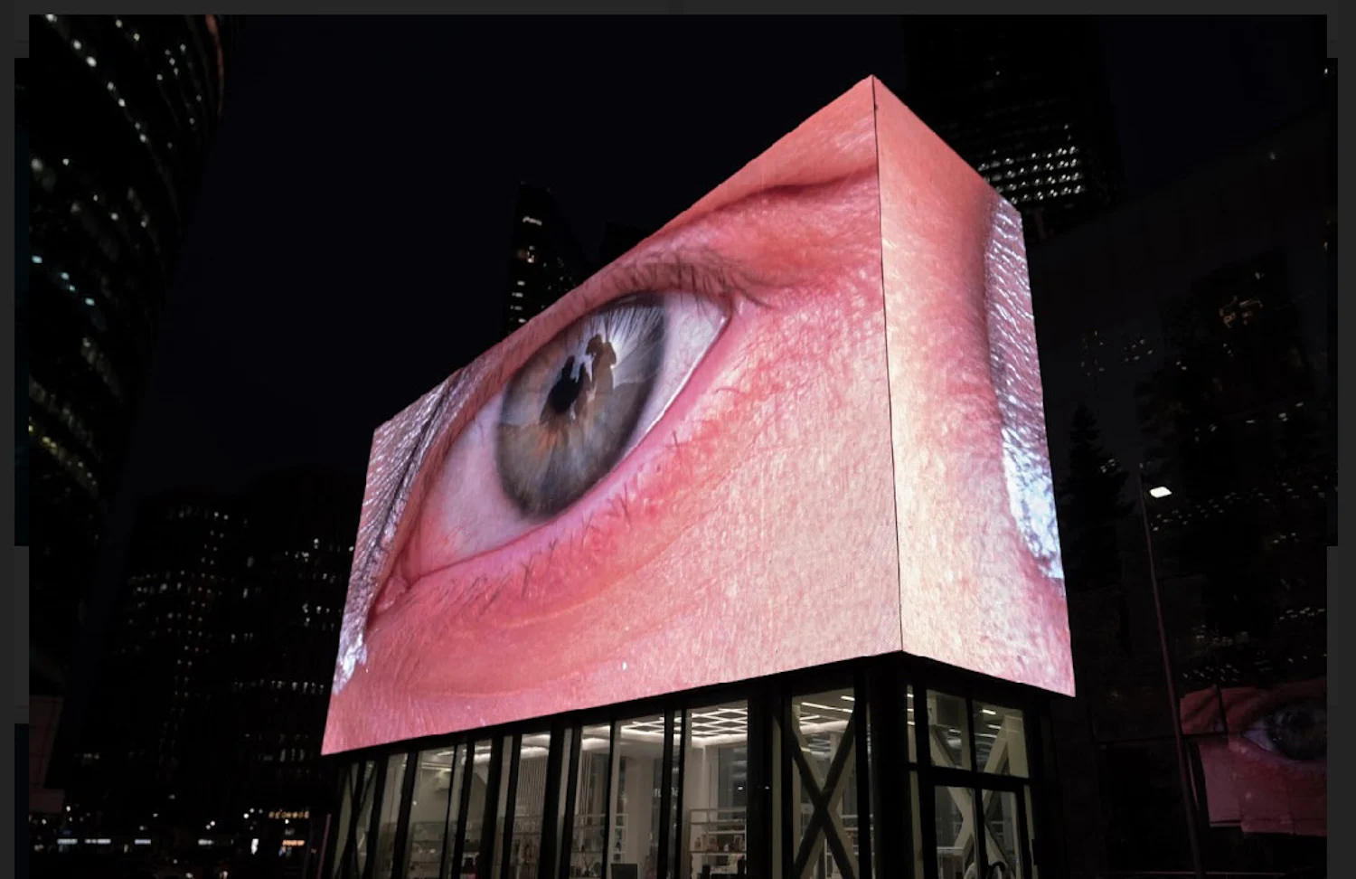 a large billboard with an image of a person's eye