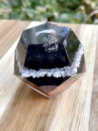 a black and white octahedron on a wooden table