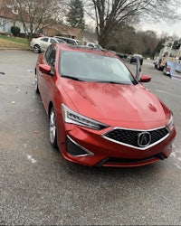 a red 2019 acura ilx is parked in a parking lot