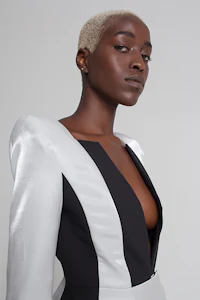 a black woman in a white and black dress