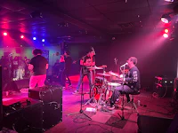 a group of people playing music in a dark room