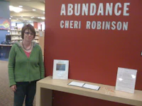 a woman standing in front of a sign