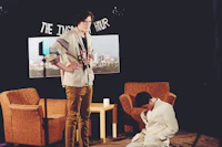 a man is kneeling on the floor next to a chair