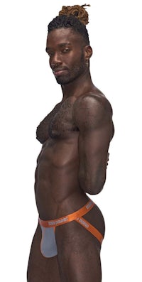 a black man in a thong posing for a photo