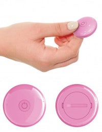 a woman's hand is holding a pink button
