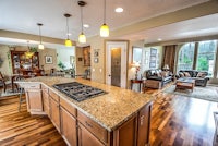a large kitchen with hardwood floors and granite counter tops
