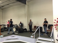 a group of people standing on stage in a church