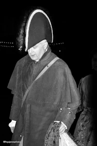 a man dressed in a period costume with a hat