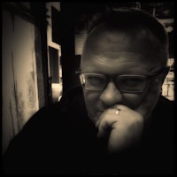 a black and white photo of a man with glasses