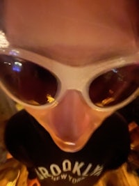 a person wearing sunglasses in a bar