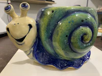a ceramic mug with a snail on it