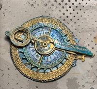 a blue and gold key on a piece of paper
