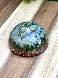 a glass sphere sitting on top of a wooden table