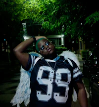 a woman in a jersey with wings posing at night
