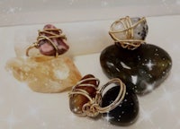 a gold ring with stones and crystals on it
