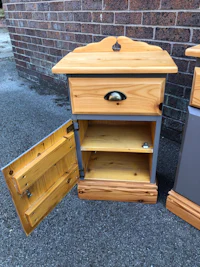 two wooden nightstands with drawers open