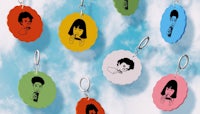 a group of colorful keychains with faces on them