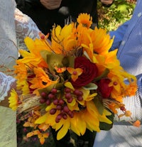 a bride is holding a bouquet of flowers