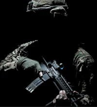 a silhouette of a soldier holding a rifle in the dark
