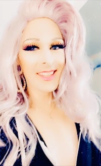 a woman with long pink hair posing for a selfie