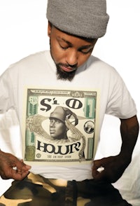 a man wearing a white t - shirt with a dollar bill on it