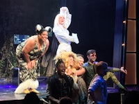 a group of people standing on stage on a stage