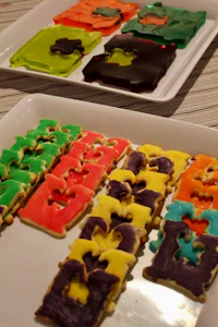 a tray of colorful shaped cookies on a table
