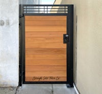 a wooden gate on a side of a building