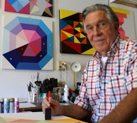 a man wearing a red and white checkered shirt