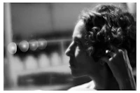 a black and white photo of a woman with curly hair