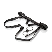 a black leather harness with a metal ring on it