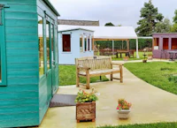 a group of colorful wooden huts in a garden