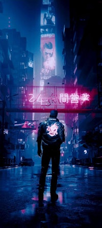 a man standing on a city street at night