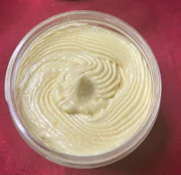 a bowl of whipped cream sitting on a red table