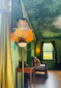 a room with green walls and a lamp