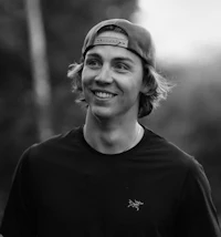 a black and white photo of a young man smiling