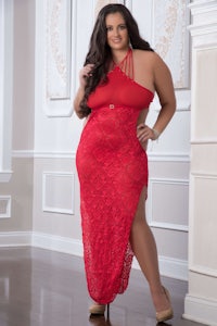 a woman in a red lace dress posing in front of a wall