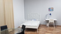a small room with a bed and a desk