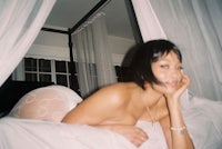 a naked woman laying on a bed