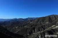 a view of a mountain range with a blue sky