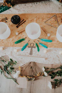 a table with candles, feathers, and other items on it