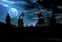 silhouettes of statues and a full moon