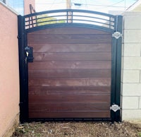 a wooden gate with a black metal frame